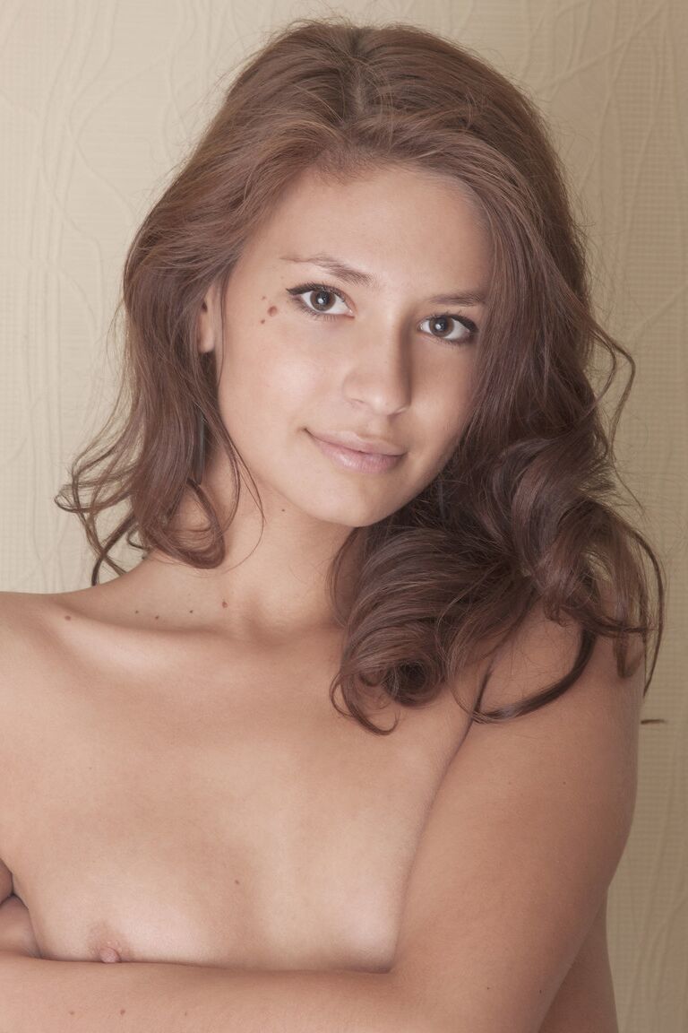 21P Slim model Irina J stripping and showing her warm snatch on a chair