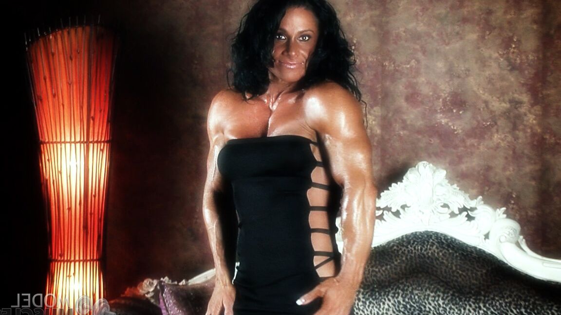 21P Brunette bodybuilder Debbie Bramwell flexing her strong body & her tight ass
