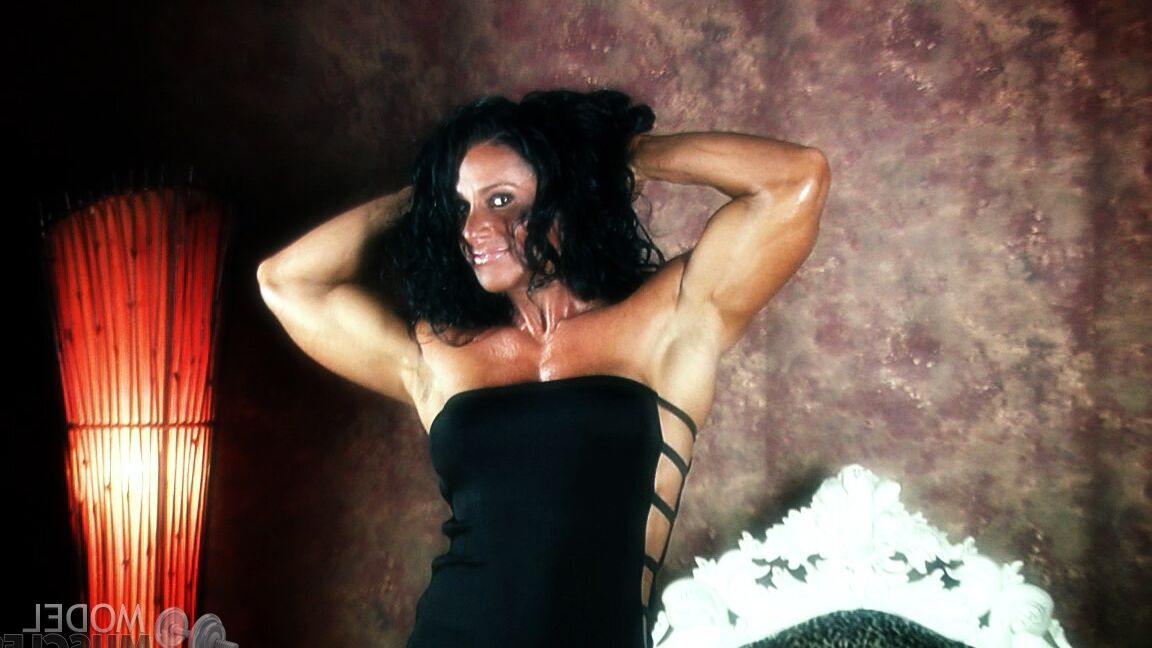 21P Brunette bodybuilder Debbie Bramwell flexing her strong body & her tight ass