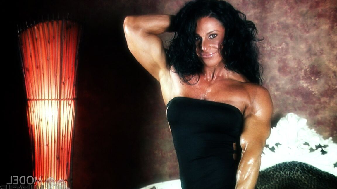 21P Brunette bodybuilder Debbie Bramwell flexing her strong body & her tight ass