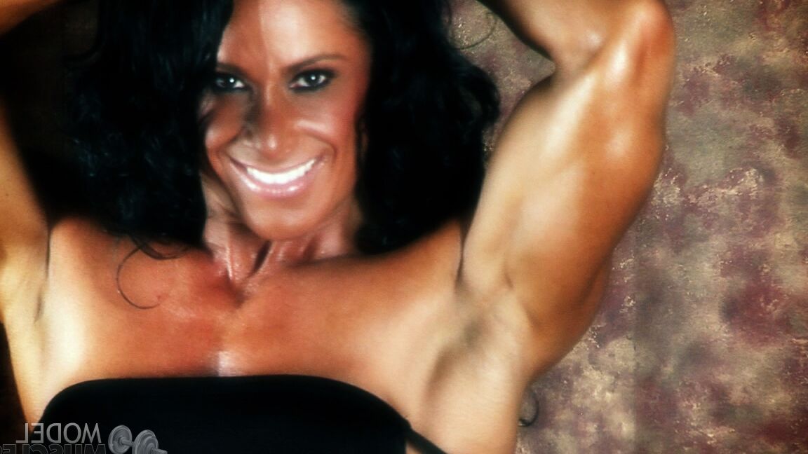 21P Brunette bodybuilder Debbie Bramwell flexing her strong body & her tight ass