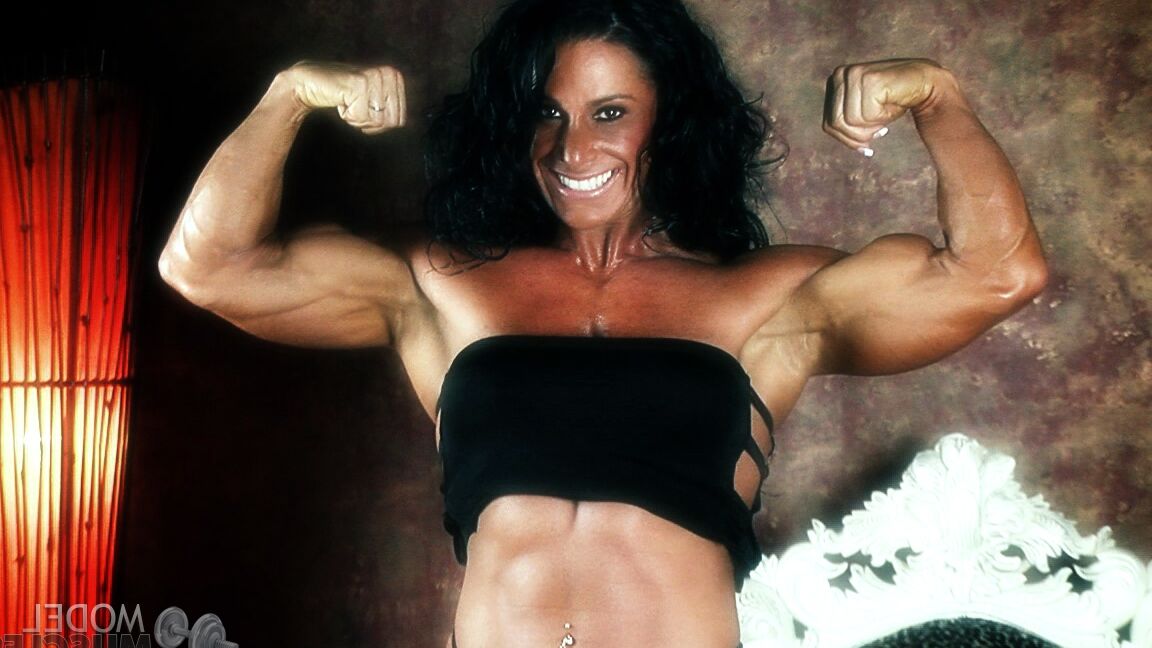 21P Brunette bodybuilder Debbie Bramwell flexing her strong body & her tight ass