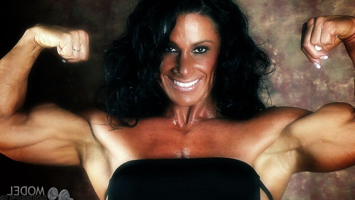 21P Brunette bodybuilder Debbie Bramwell flexing her strong body & her tight ass