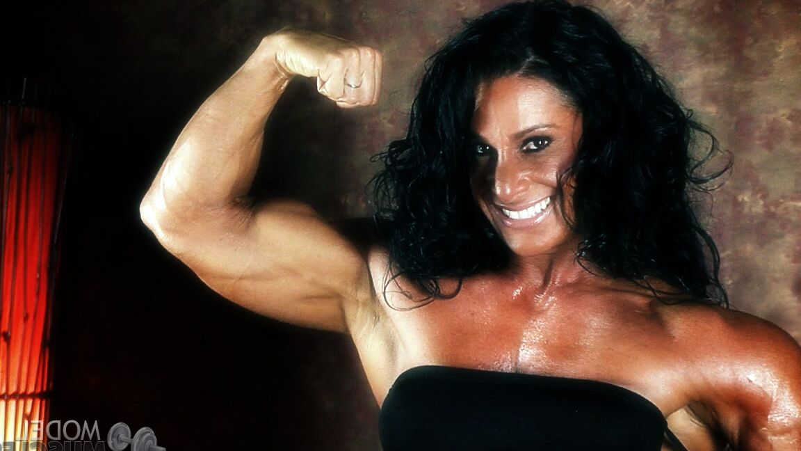 21P Brunette bodybuilder Debbie Bramwell flexing her strong body & her tight ass