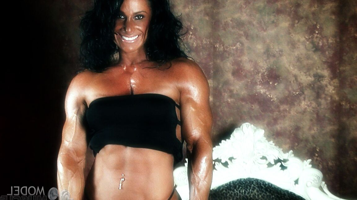 21P Brunette bodybuilder Debbie Bramwell flexing her strong body & her tight ass