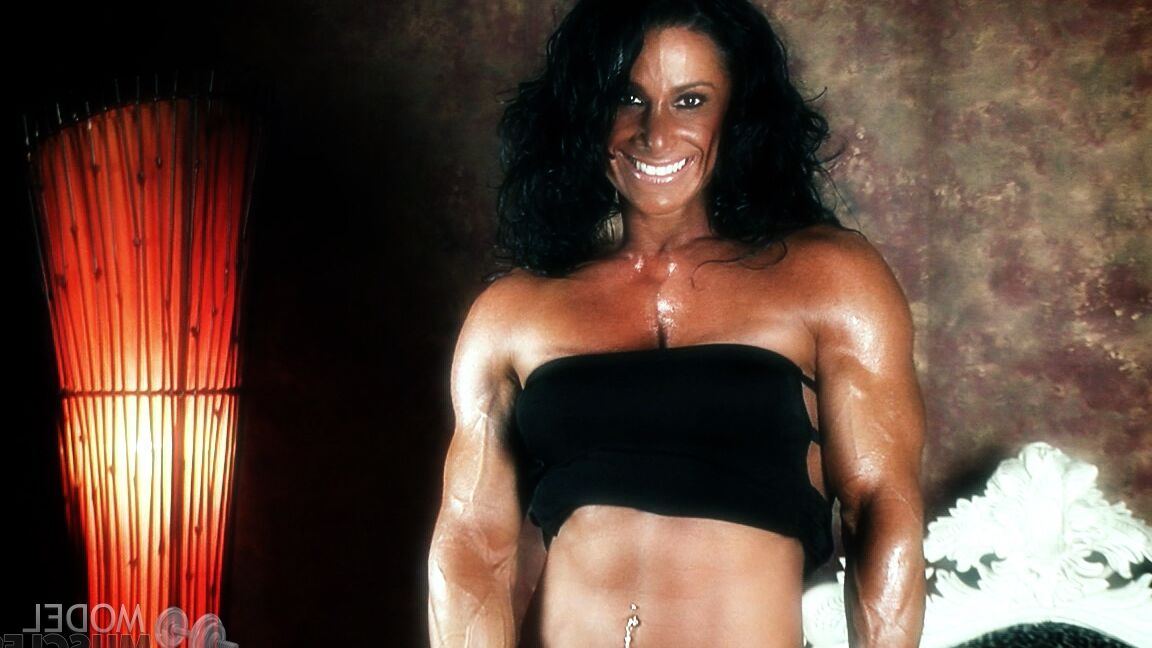 21P Brunette bodybuilder Debbie Bramwell flexing her strong body & her tight ass