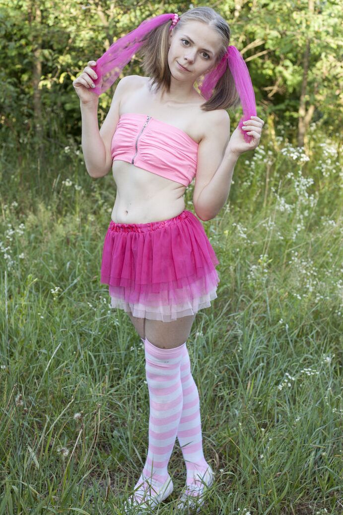 16P Young looking girl Nastyshka shows her tiny tits and tight slit in a field