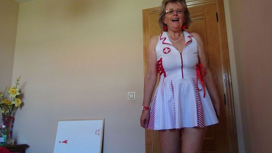 20P Old lady Abby Roberts frees sagging tits from nurse outfit before dildo riding