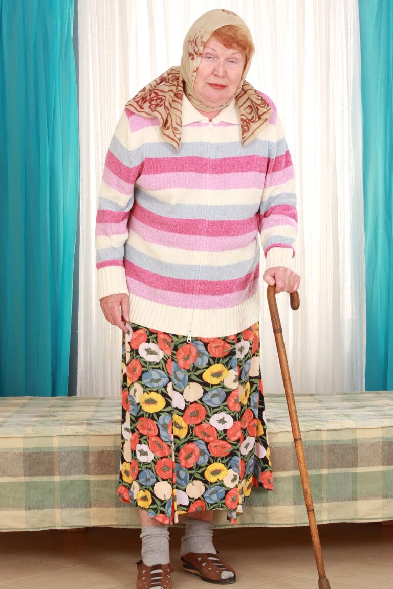15P Fat old granny Alice with cane posing fully clothed in long skirt and socks