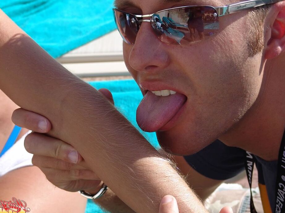 15P Fully clothed female Lori Anderson has her hairy arms licked near a pool