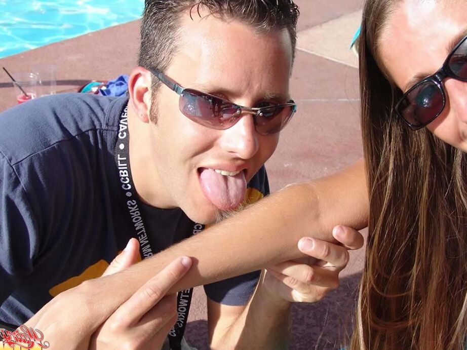 15P Fully clothed female Lori Anderson has her hairy arms licked near a pool