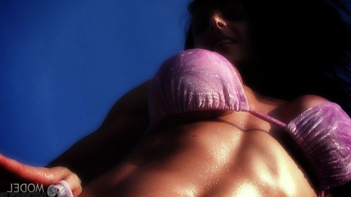 21P Die amerikanische Bodybuilderin Elise Penn stellt ihre glänzenden Bauchmuskeln und ihren Körper im Freien zur Schau