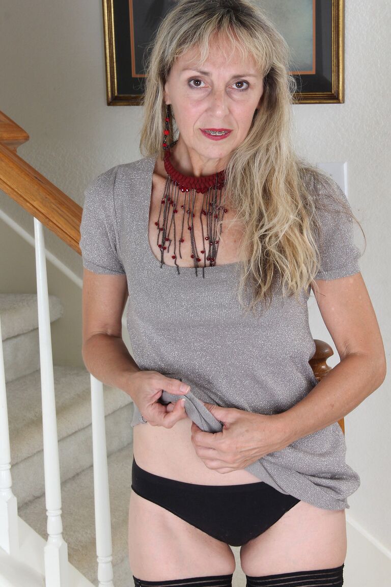 21P GILF Sienna strips to her stockings & touches her hairy pussy in the hallway