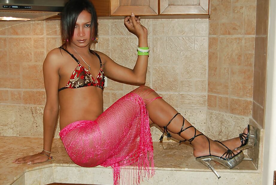 16P Petite Asian ladyboy Yoyo spreading to expose large shecock under skirt