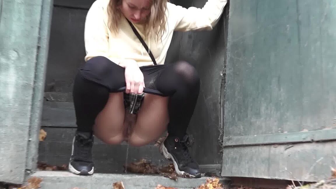 15P Caucasian girl takes a piss in an outhouse while in a forest