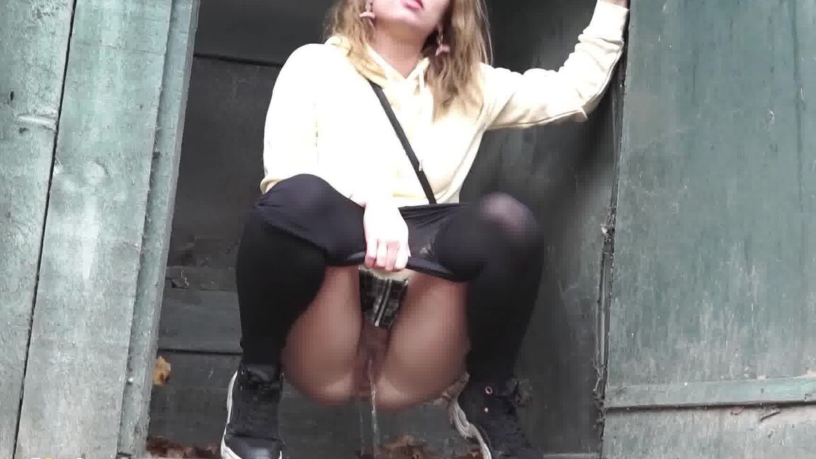 15P Caucasian girl takes a piss in an outhouse while in a forest