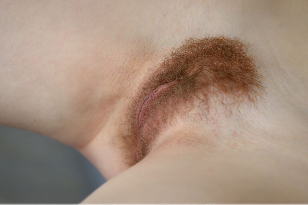 16P Horny redhead Adel P fondles nipples, spreading wide open to show hairy pussy