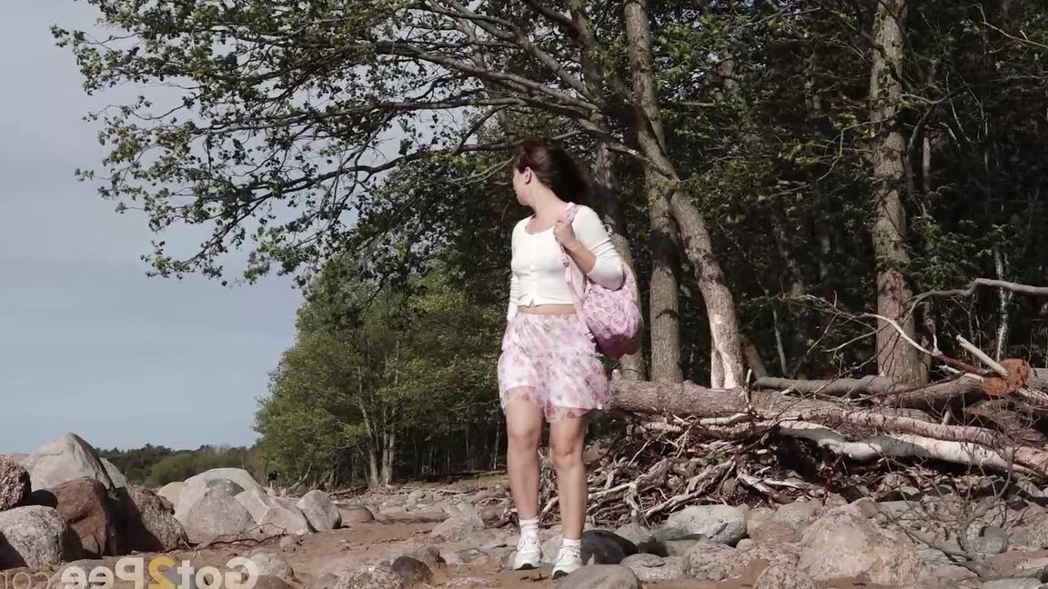 15P European babe squats over rocks to piss outside