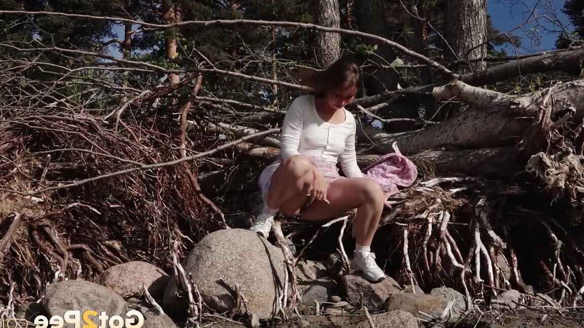 15P European babe squats over rocks to piss outside
