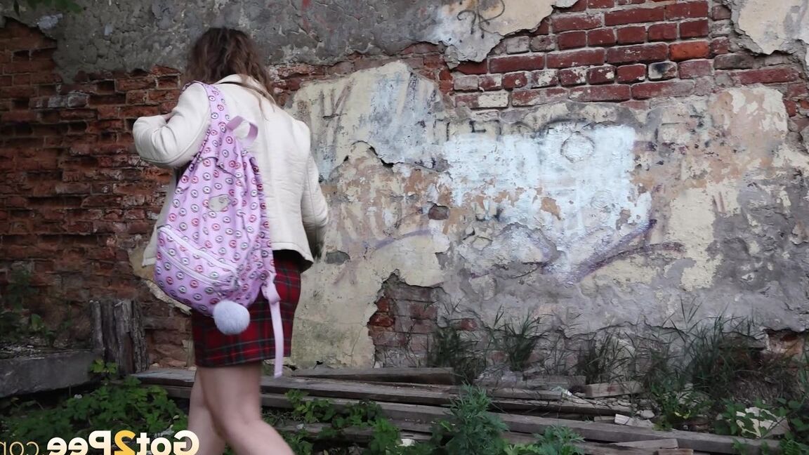 15P Short taken girl Rita ducks behind a building for a badly needed piss