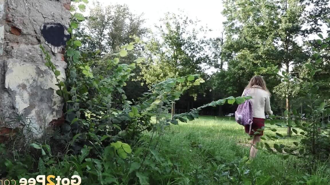 15P Short taken girl Rita ducks behind a building for a badly needed piss