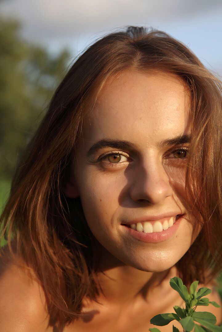 12P Young redhead grabs her ass while spreading her cunt in a field of crops