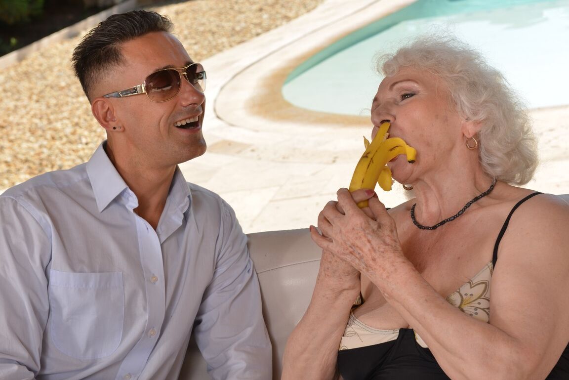 21P Grey haired granny Norma B blows a dong before taking it in her cunt poolside