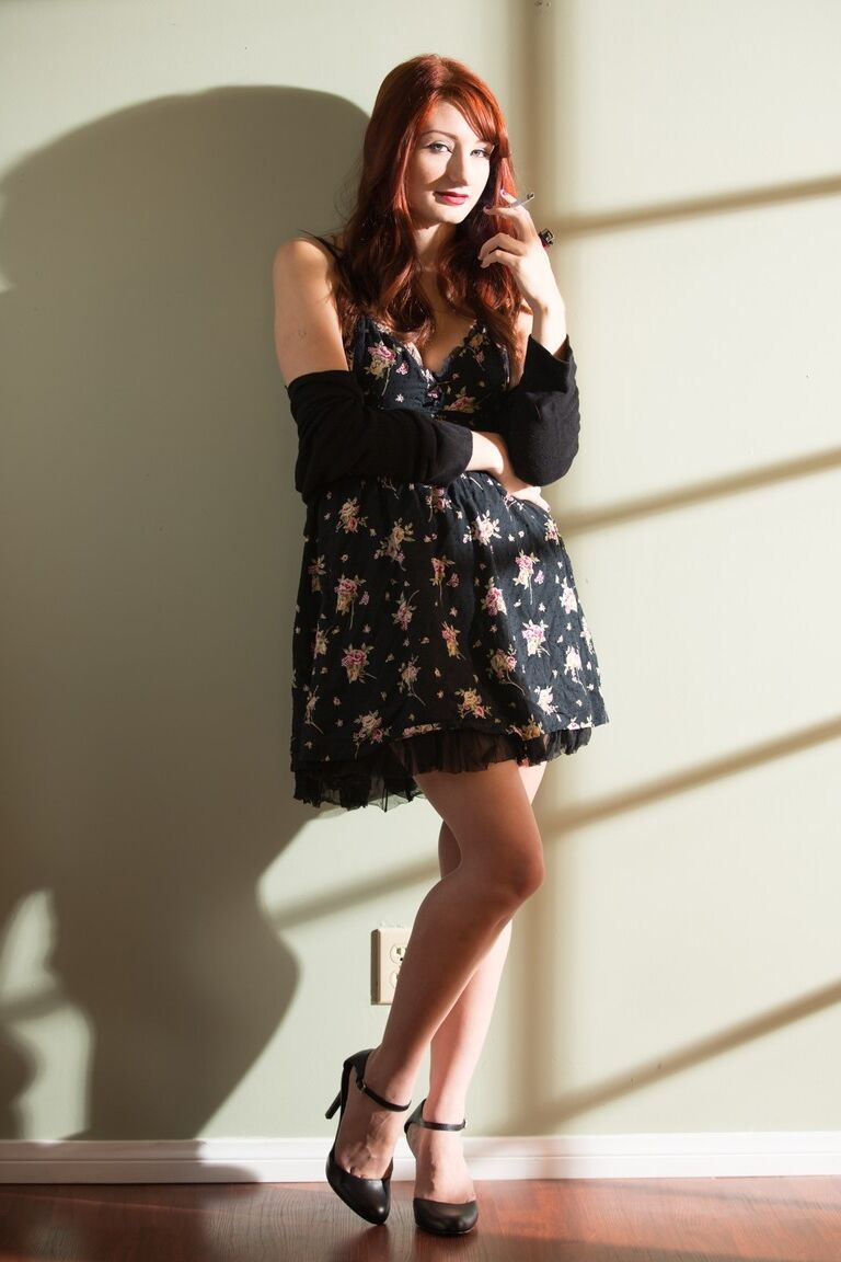 15P Smoking redhead model flashing tits and trimmed bush from underneath dress