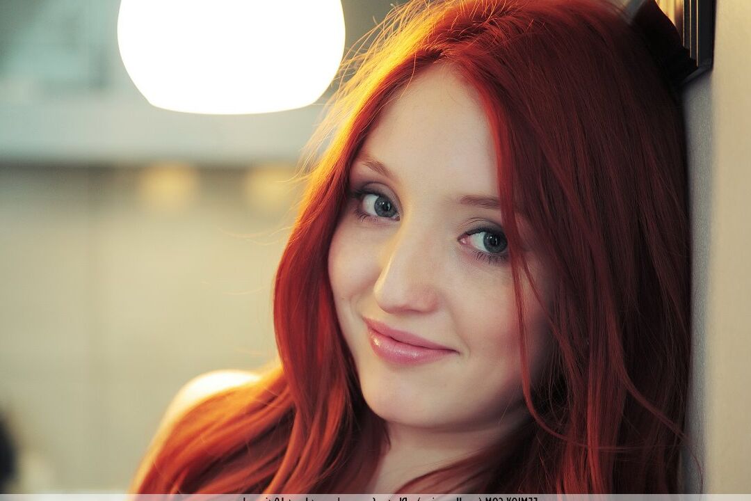 16P Young redhead Marga E displays her nice body in a kitchen while wearing heels