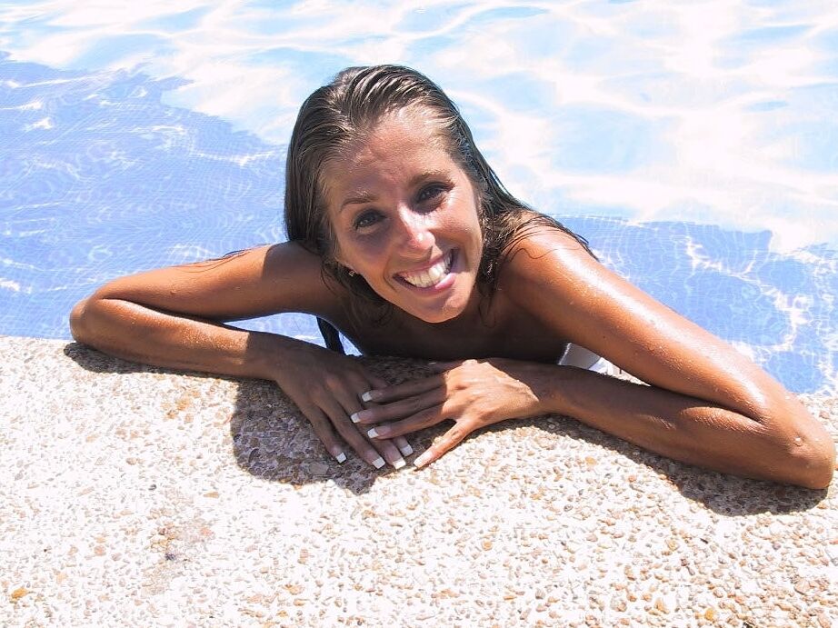 20P Sweet amateur Lori Anderson flashes her shaved muff while posing in a bikini