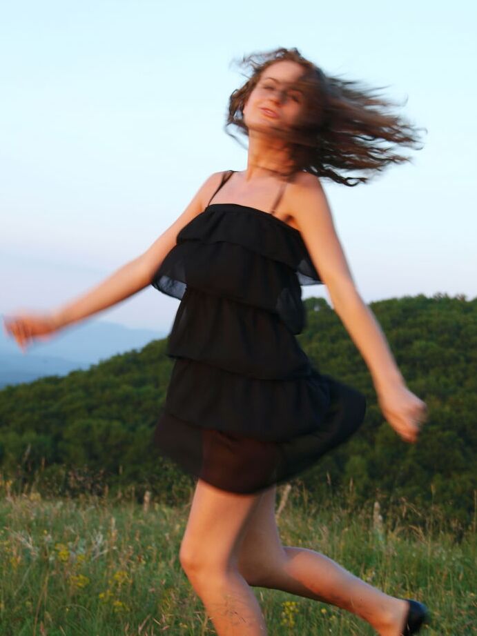 16P Young model Lili F ditches a little black dress to go bare naked in a field