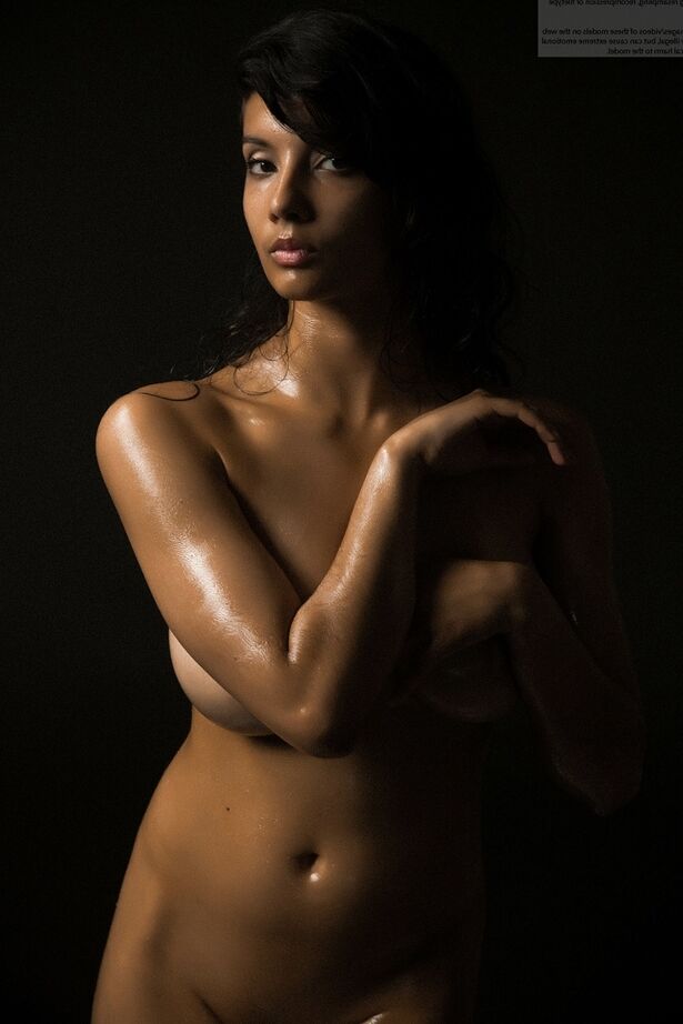 16P Naked Indian female exposes a single breast while modeling in the dark