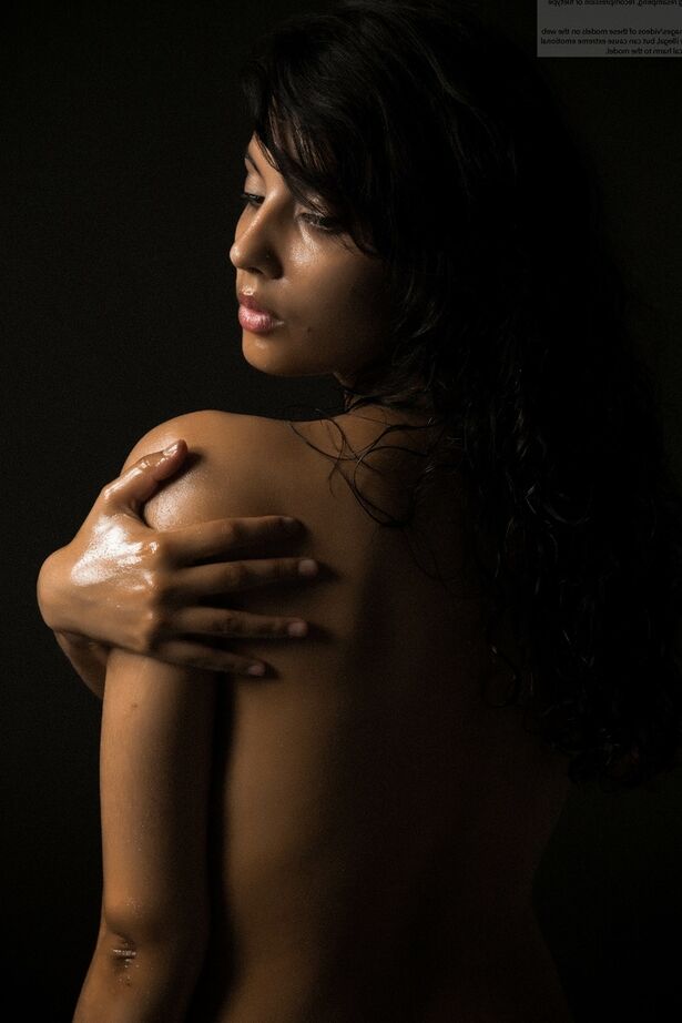 16P Naked Indian female exposes a single breast while modeling in the dark
