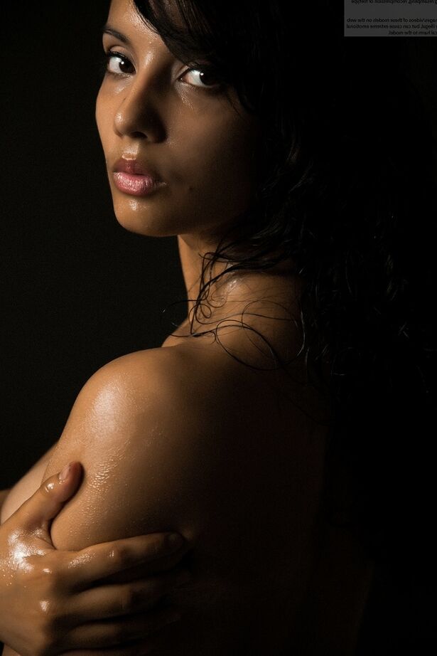 16P Naked Indian female exposes a single breast while modeling in the dark