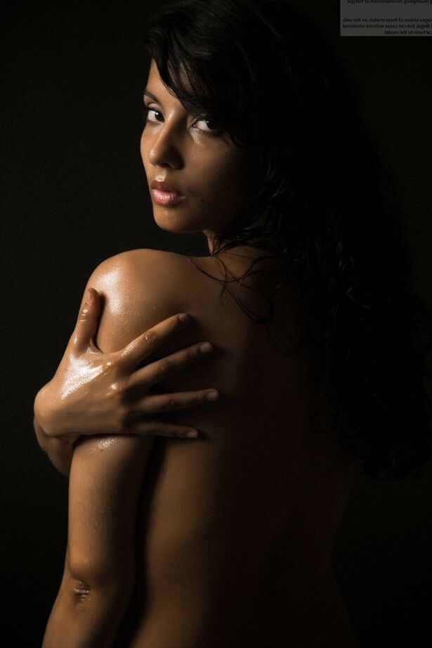 16P Naked Indian female exposes a single breast while modeling in the dark