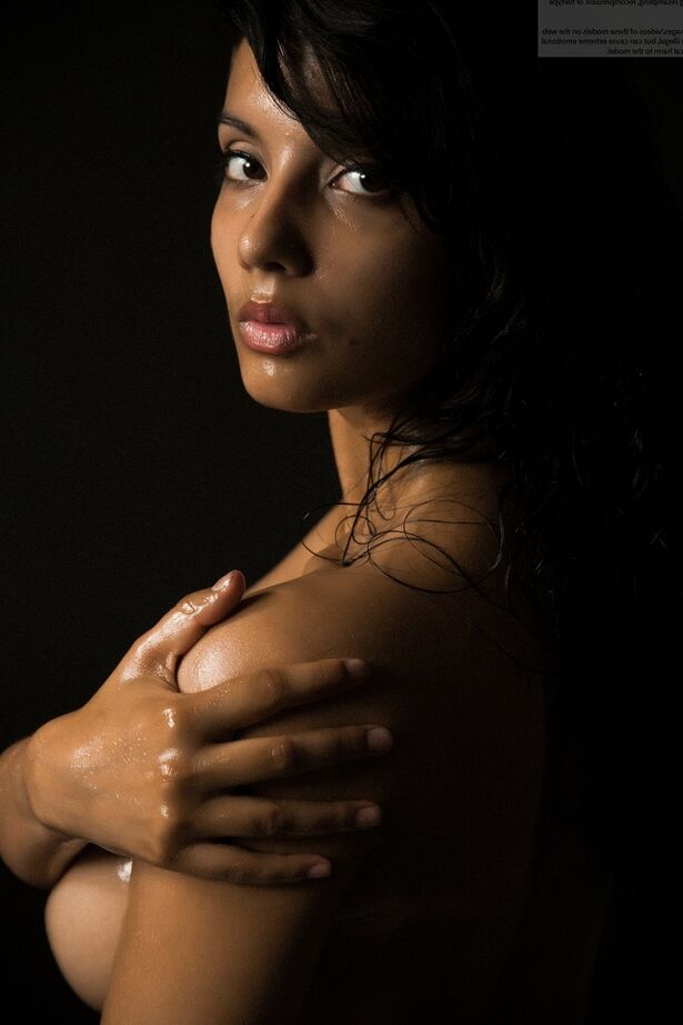 16P Naked Indian female exposes a single breast while modeling in the dark