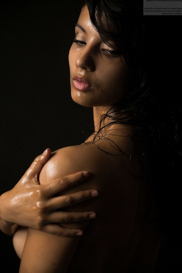 16P Naked Indian female exposes a single breast while modeling in the dark