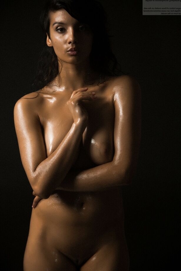 16P Naked Indian female exposes a single breast while modeling in the dark