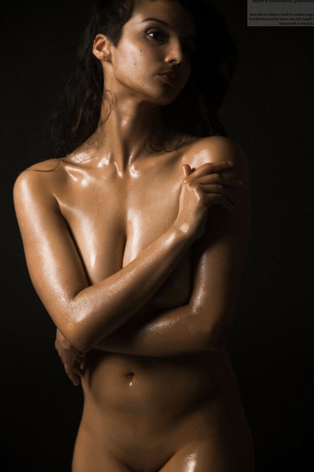16P Naked Indian female exposes a single breast while modeling in the dark