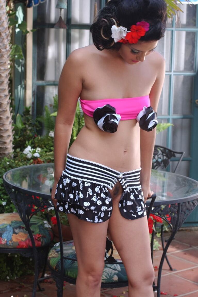 17P Pin-up brunette model Sunny Leone flaunts her sexy curves in the garden