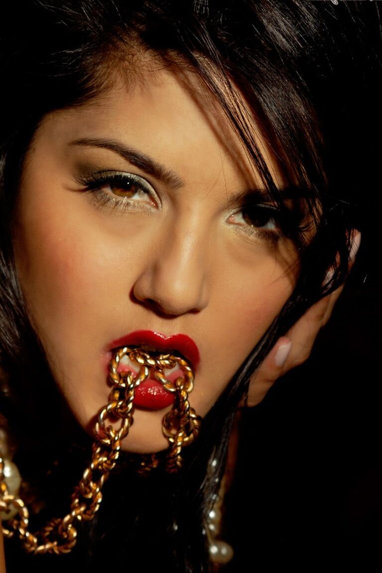 21P Sweet girl with pierced tits Sunny Leone flaunts her twat on a desk