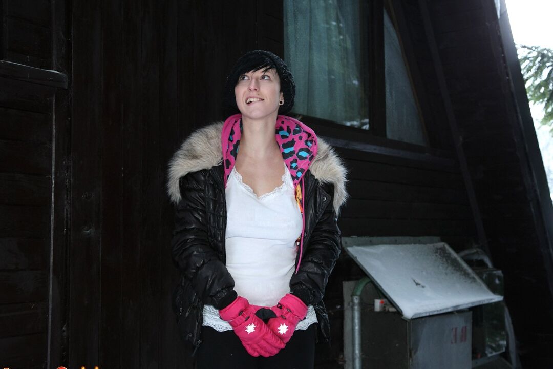 15P Barely legal brunette rubs her pussy on a snowy day behind a cabin in woods