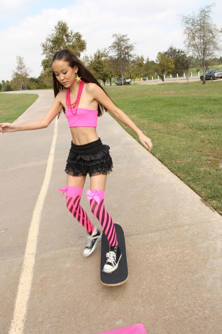 18P Tiny Asian teen Amai Liu posing in short skirt on the skateboard