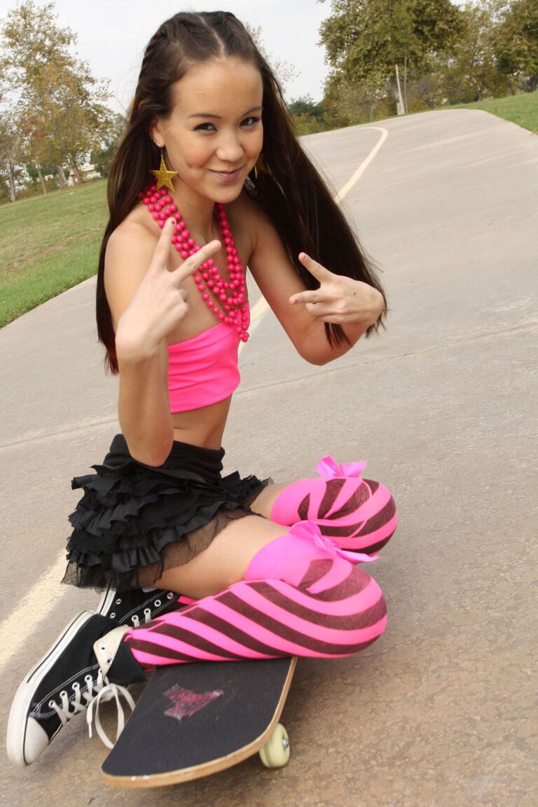 18P Tiny Asian teen Amai Liu posing in short skirt on the skateboard