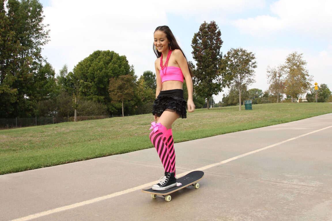 18P Tiny Asian teen Amai Liu posing in short skirt on the skateboard