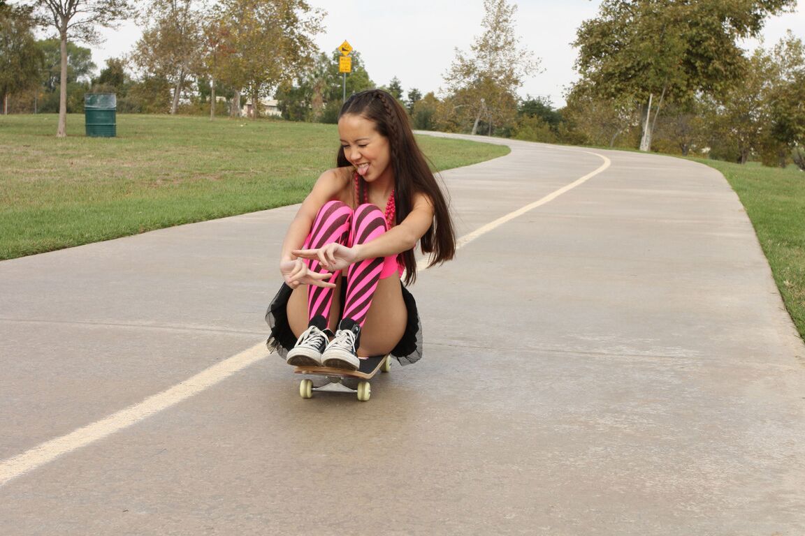 18P Tiny Asian teen Amai Liu posing in short skirt on the skateboard