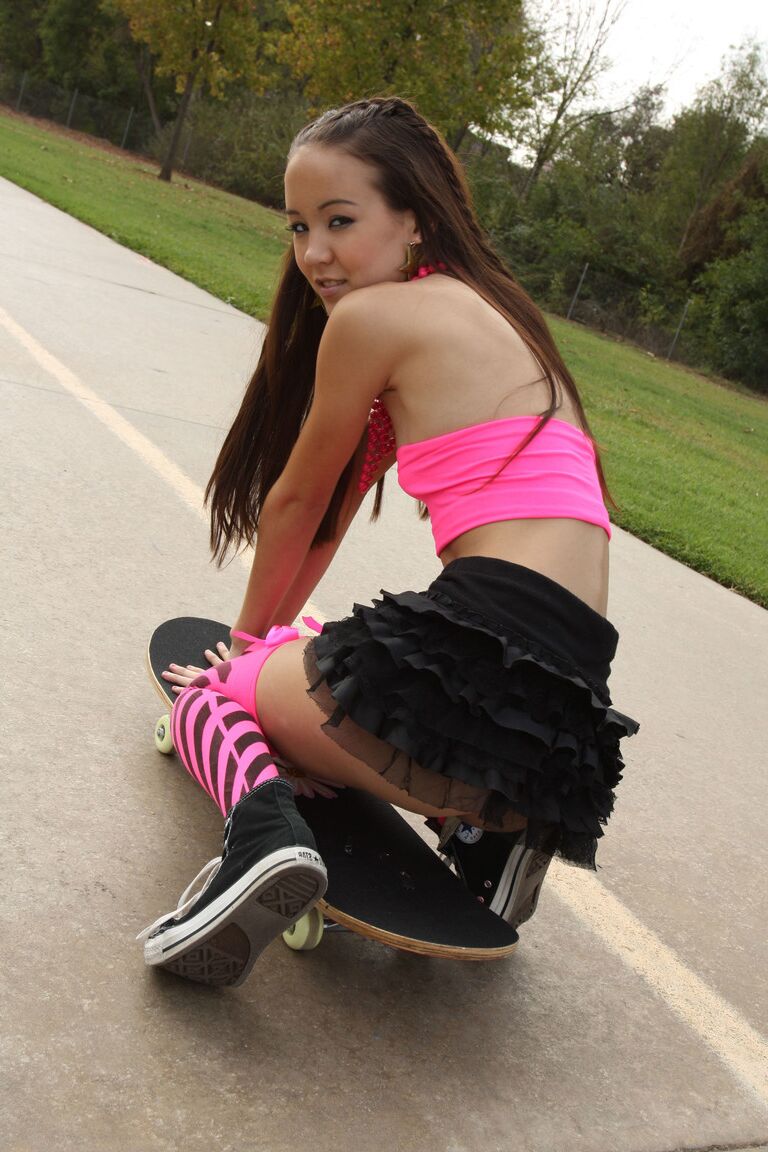 18P Tiny Asian teen Amai Liu posing in short skirt on the skateboard