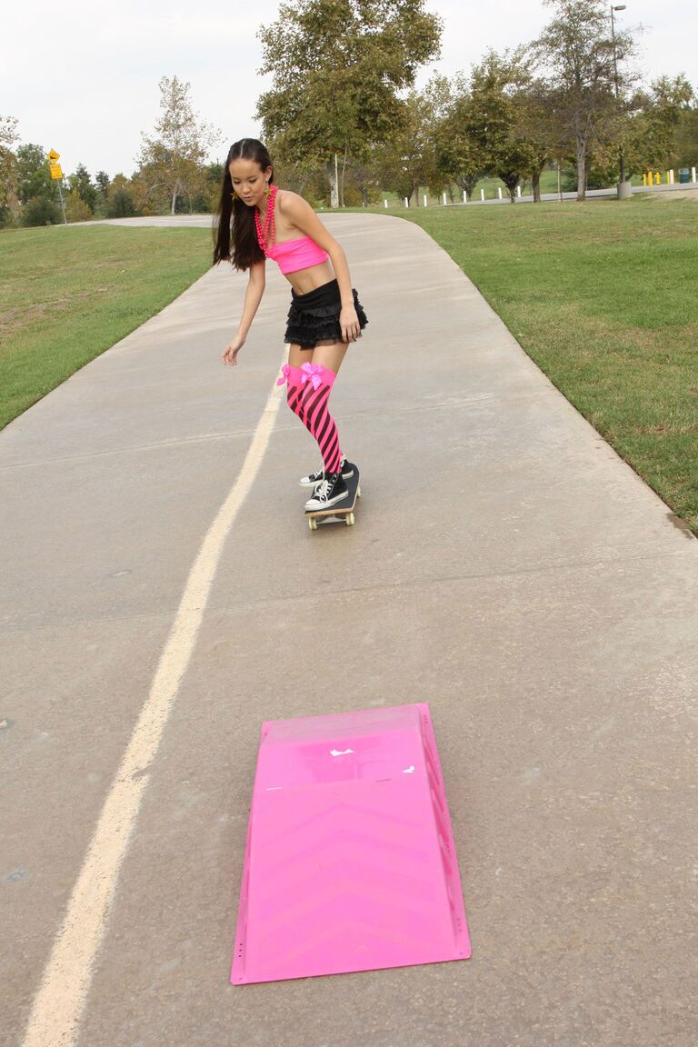 18P Tiny Asian teen Amai Liu posing in short skirt on the skateboard