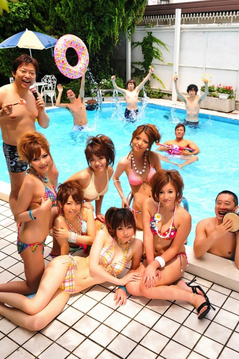 12P Japanese bikini models gather on a poolside patio for a group shoot