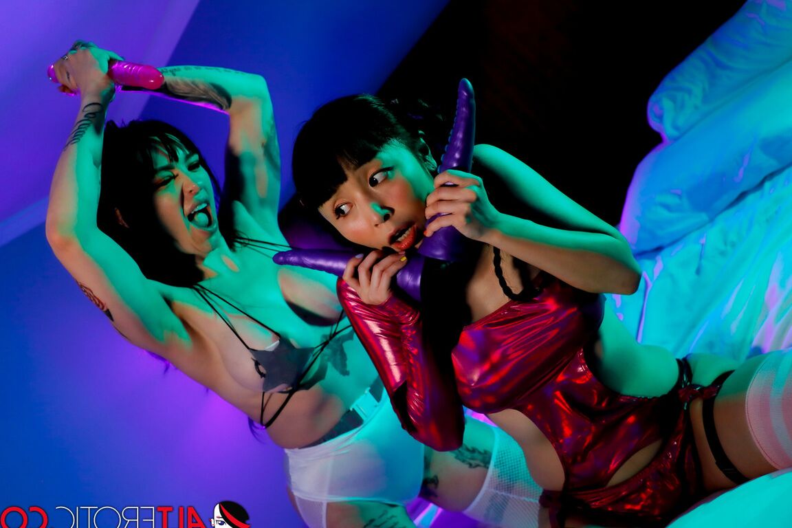 16P Marica Hase & Misha Montana partake in a dildo fight on top of a bed